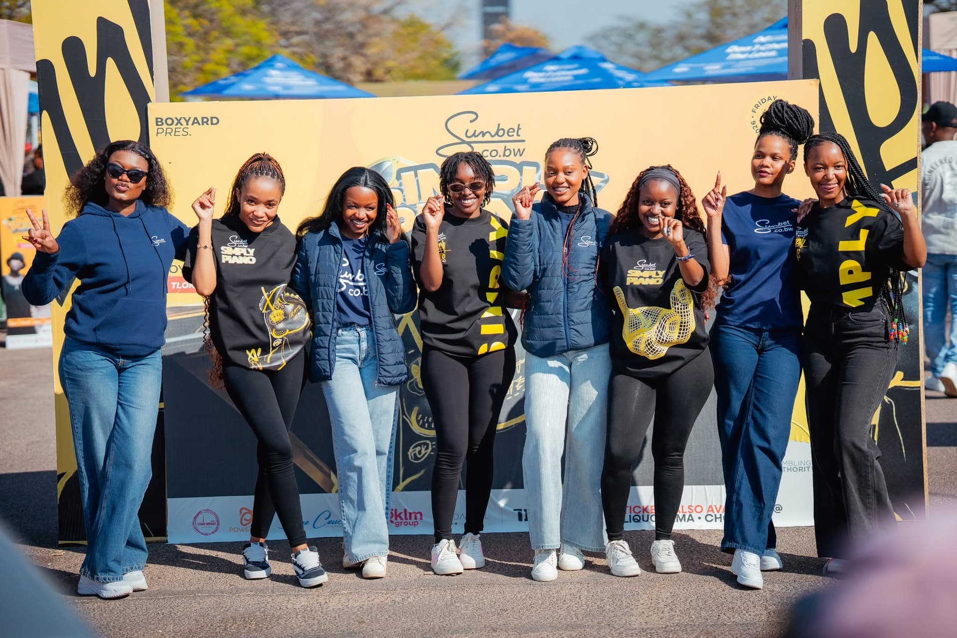 Simply Piano promotional team in branded gear at a Sunbet activation stand