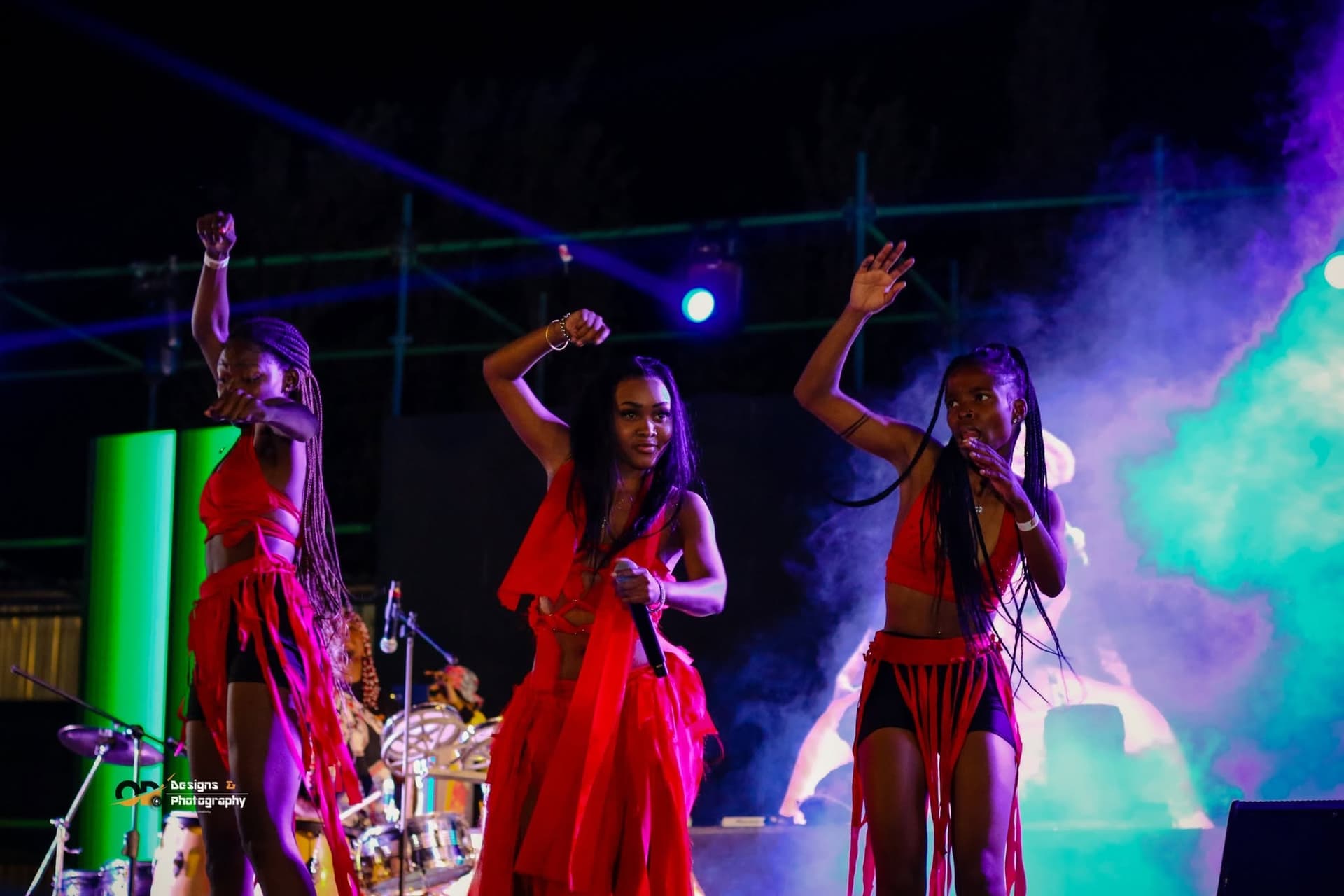 Dancers in red performing during a Simply Piano set