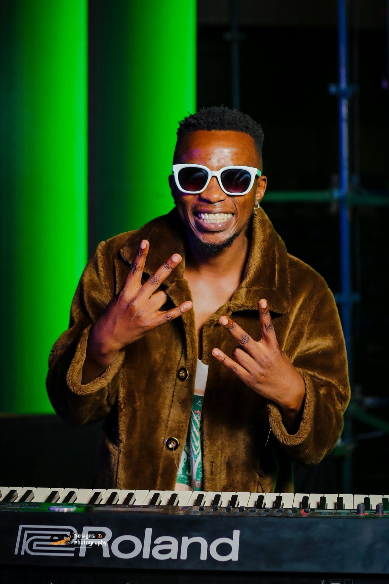 Musician in sunglasses playing keys at a Simply Piano event