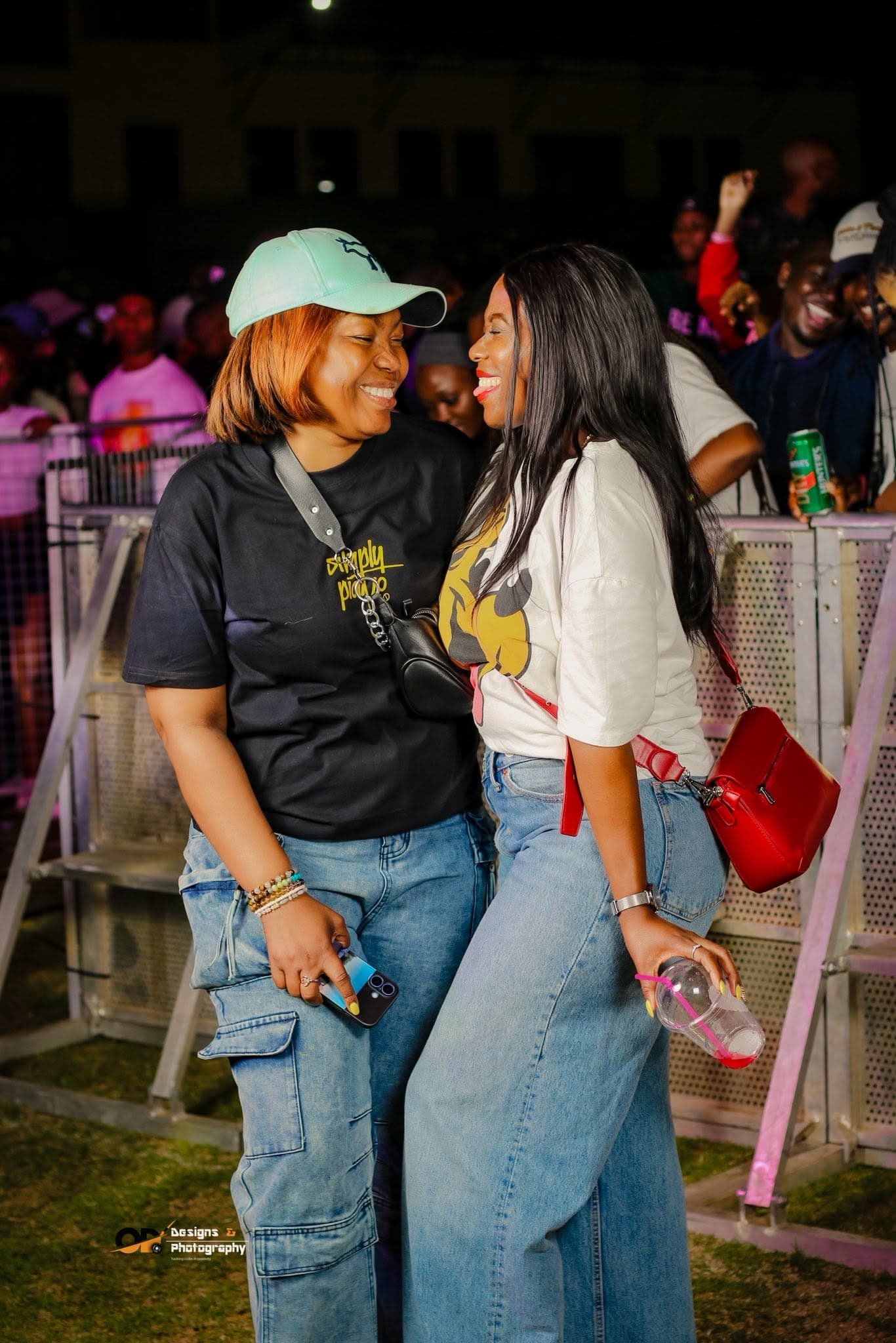 Two friends laughing together in the crowd at a Simply Piano event