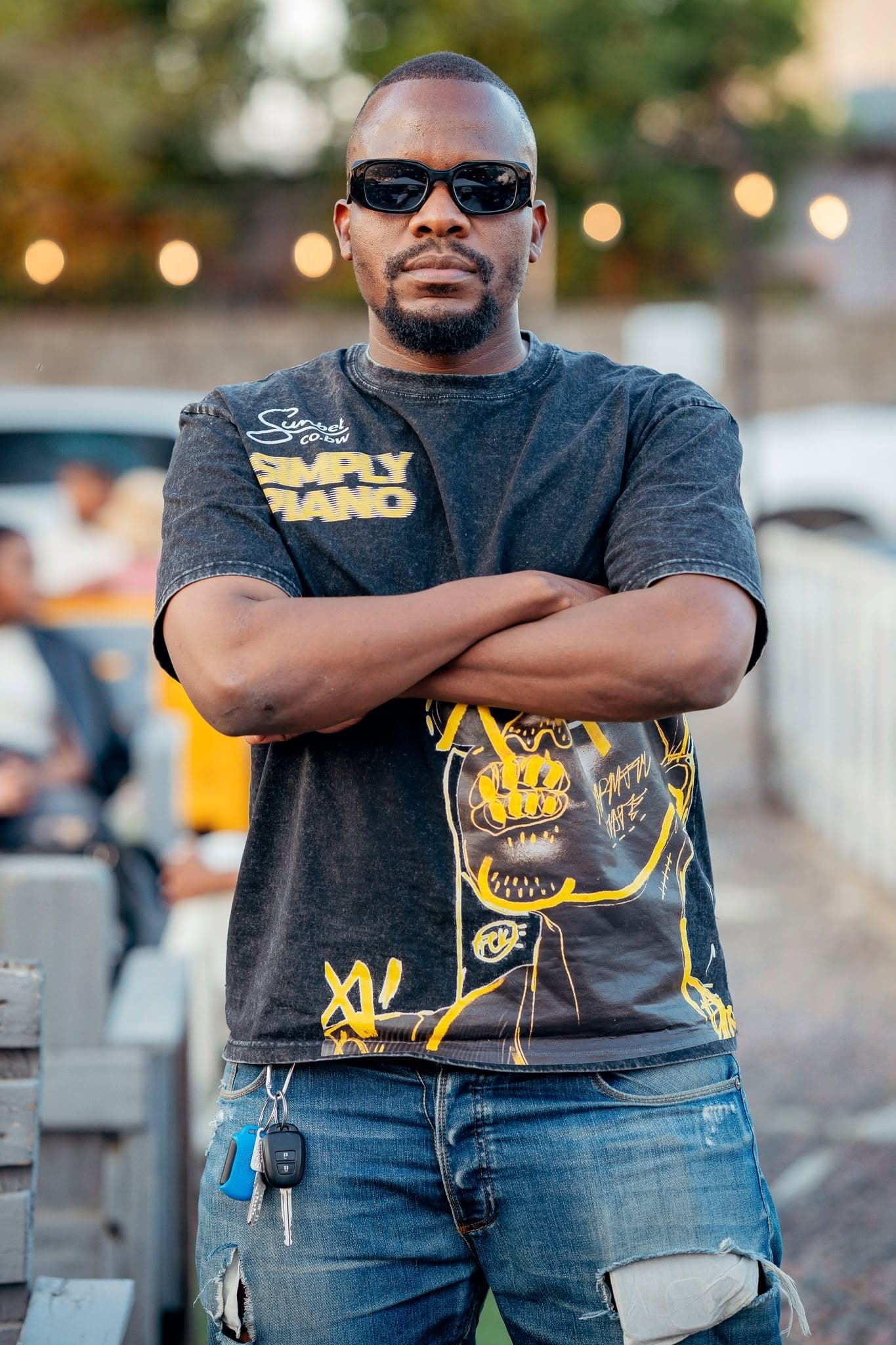 Attendee wearing a Simply Piano tee with arms folded