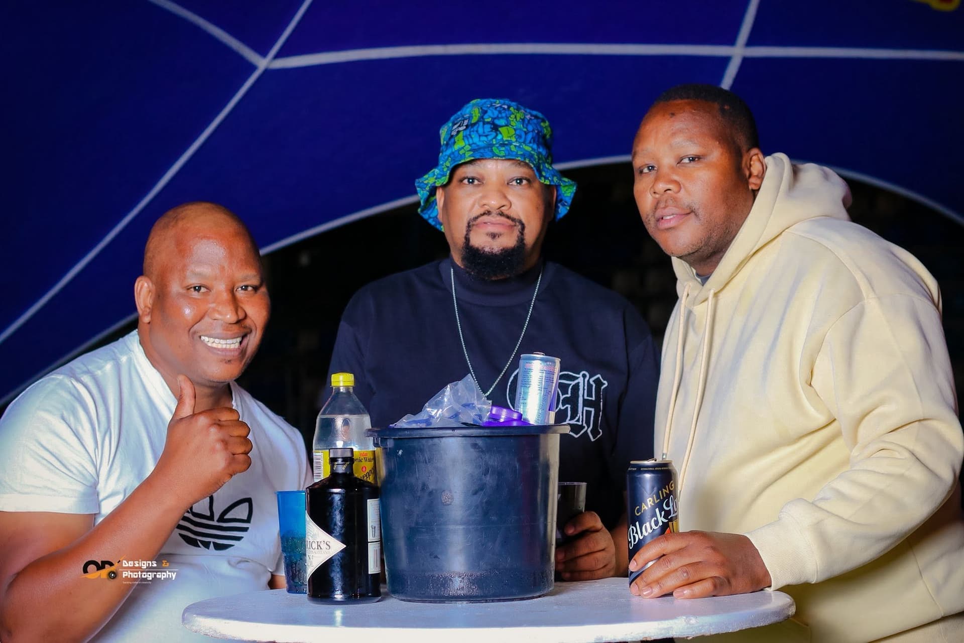 Guests sharing drinks at a table during a music event
