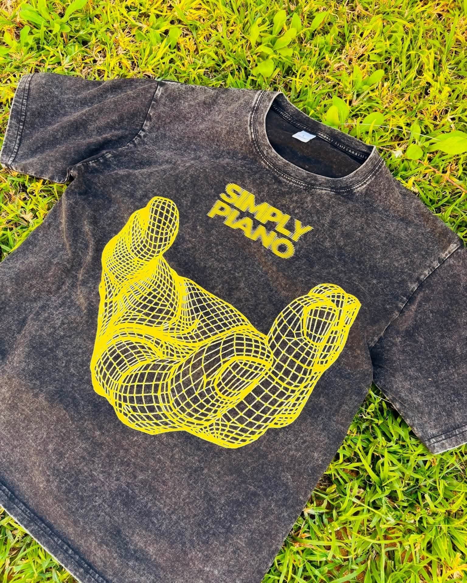 Acid-washed grey Simply Piano tee with a yellow wireframe hand graphic